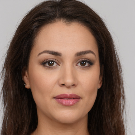 Joyful white young-adult female with long  brown hair and brown eyes