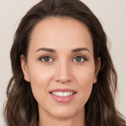 Joyful white young-adult female with long  brown hair and brown eyes