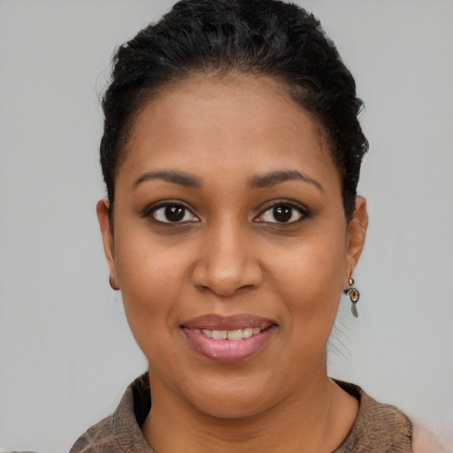 Joyful latino young-adult female with short  brown hair and brown eyes