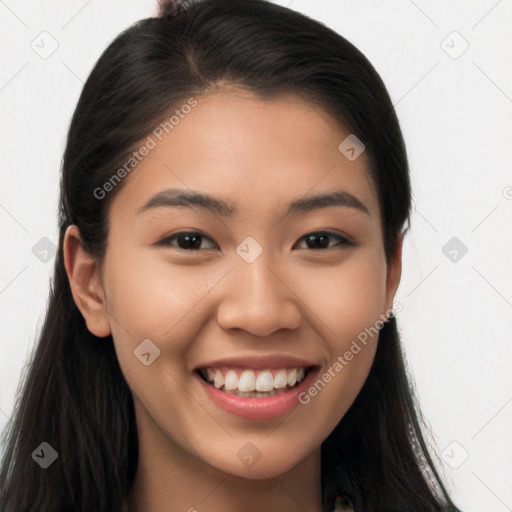 Joyful latino young-adult female with long  brown hair and brown eyes