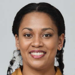 Joyful black young-adult female with medium  brown hair and brown eyes