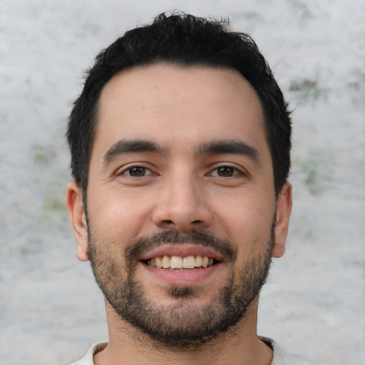 Joyful white young-adult male with short  black hair and brown eyes