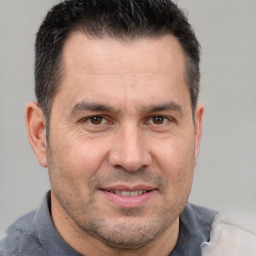 Joyful white adult male with short  brown hair and brown eyes