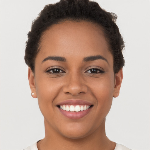 Joyful latino young-adult female with short  brown hair and brown eyes