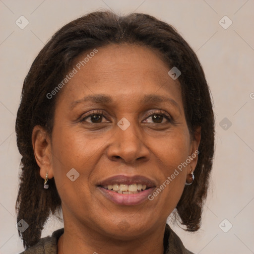 Joyful black adult female with medium  brown hair and brown eyes