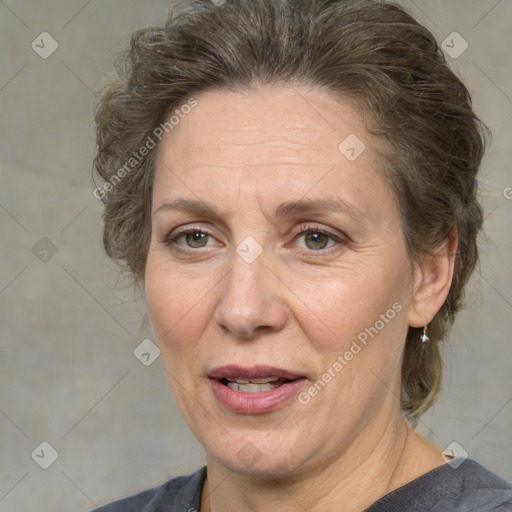 Joyful white adult female with medium  brown hair and grey eyes