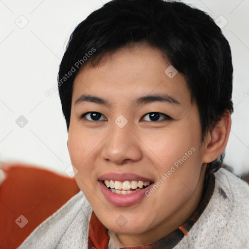 Joyful asian young-adult female with short  black hair and brown eyes