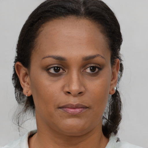 Joyful black young-adult female with medium  brown hair and brown eyes