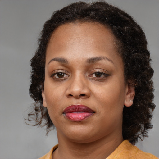 Joyful black young-adult female with medium  brown hair and brown eyes
