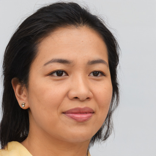 Joyful asian young-adult female with long  brown hair and brown eyes