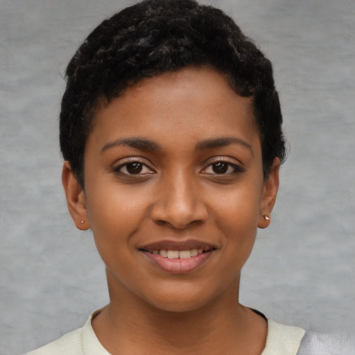 Joyful latino young-adult female with short  black hair and brown eyes