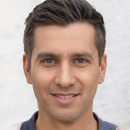 Joyful white young-adult male with short  brown hair and brown eyes