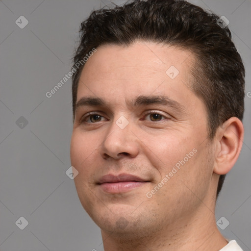 Joyful white adult male with short  brown hair and brown eyes