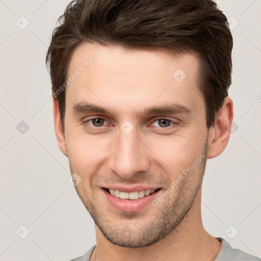 Joyful white young-adult male with short  brown hair and brown eyes