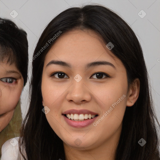 Joyful asian young-adult female with long  brown hair and brown eyes