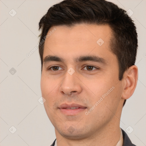 Joyful white young-adult male with short  black hair and brown eyes