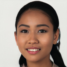 Joyful latino young-adult female with long  black hair and brown eyes