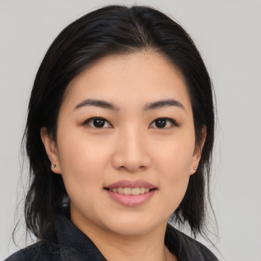 Joyful asian young-adult female with medium  black hair and brown eyes