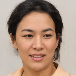 Joyful asian young-adult female with medium  brown hair and brown eyes