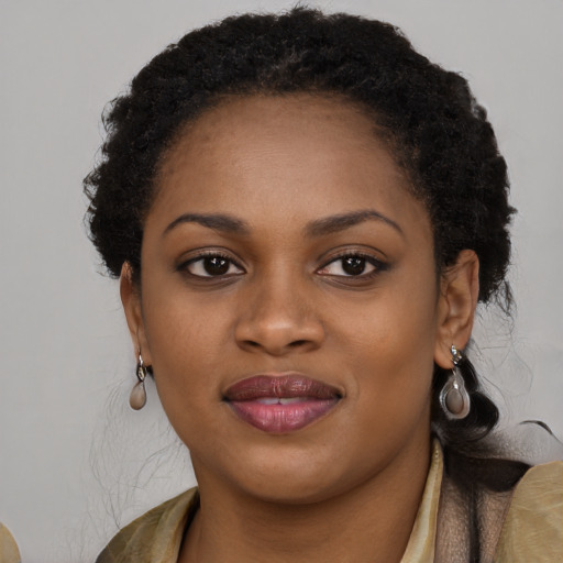 Joyful black young-adult female with medium  brown hair and brown eyes