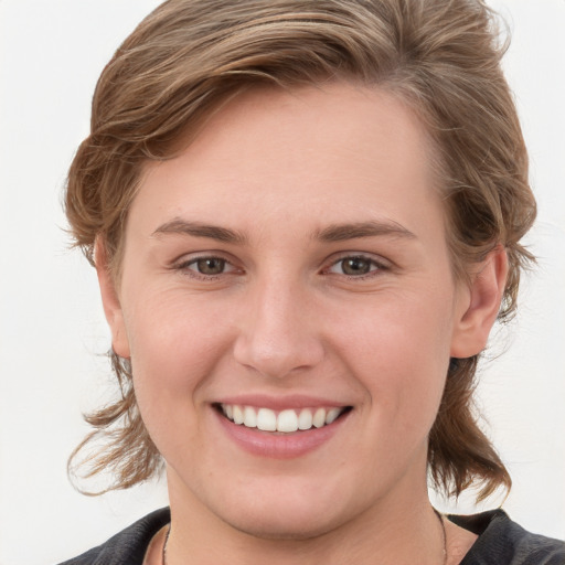 Joyful white young-adult female with medium  brown hair and grey eyes