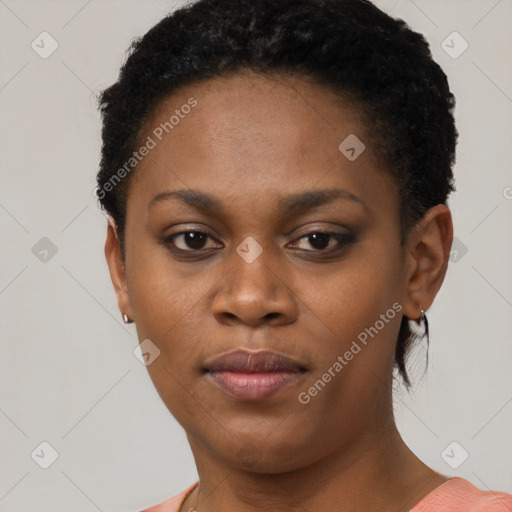 Joyful black young-adult female with short  brown hair and brown eyes