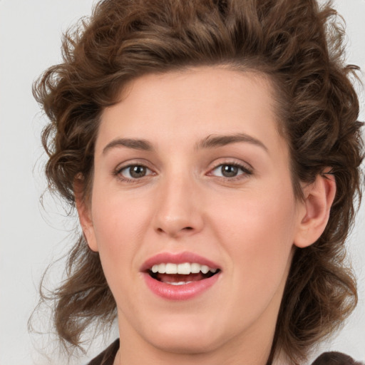 Joyful white young-adult female with medium  brown hair and green eyes