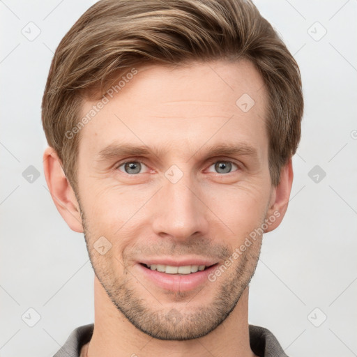 Joyful white young-adult male with short  brown hair and grey eyes