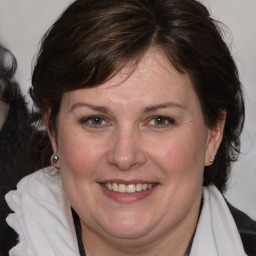 Joyful white adult female with medium  brown hair and brown eyes