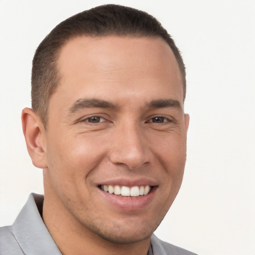 Joyful white young-adult male with short  brown hair and brown eyes