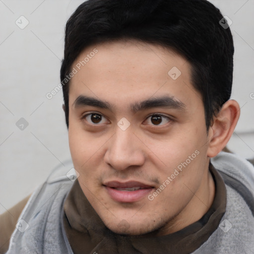Joyful asian young-adult male with short  black hair and brown eyes