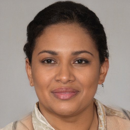 Joyful latino adult female with short  brown hair and brown eyes