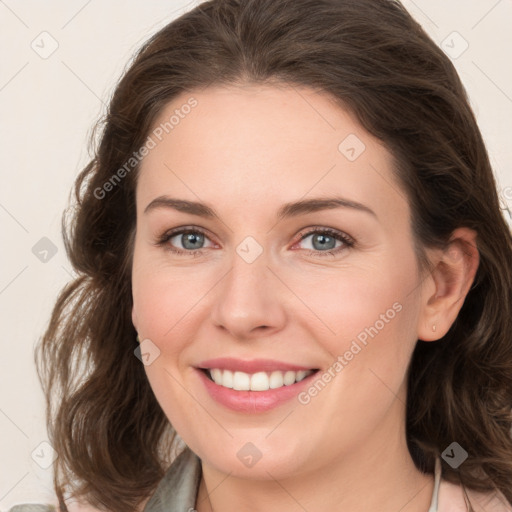 Joyful white young-adult female with medium  brown hair and green eyes