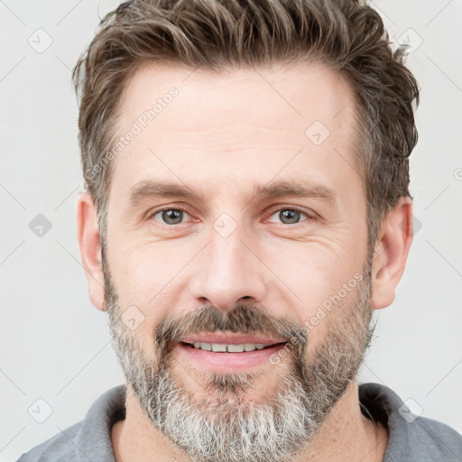 Joyful white adult male with short  brown hair and grey eyes