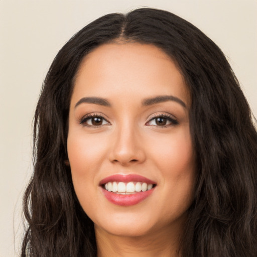 Joyful white young-adult female with long  black hair and brown eyes