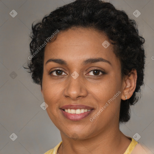 Joyful black young-adult female with short  brown hair and brown eyes