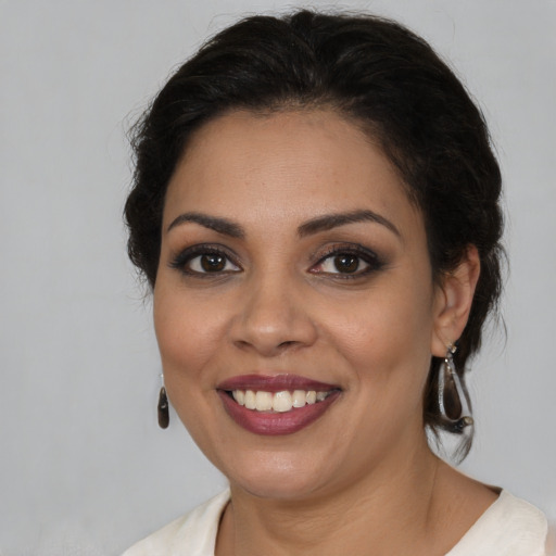 Joyful latino young-adult female with medium  brown hair and brown eyes