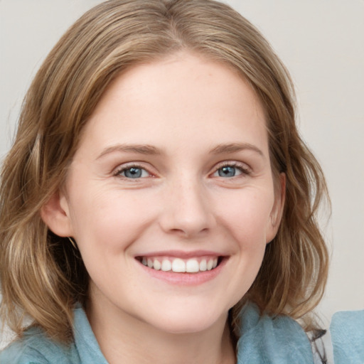 Joyful white young-adult female with medium  brown hair and blue eyes