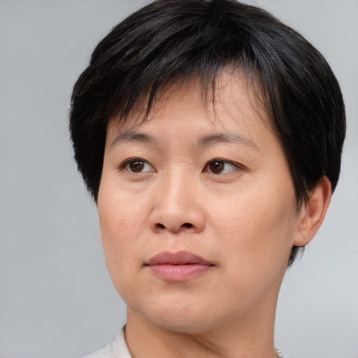 Joyful asian adult female with short  brown hair and brown eyes