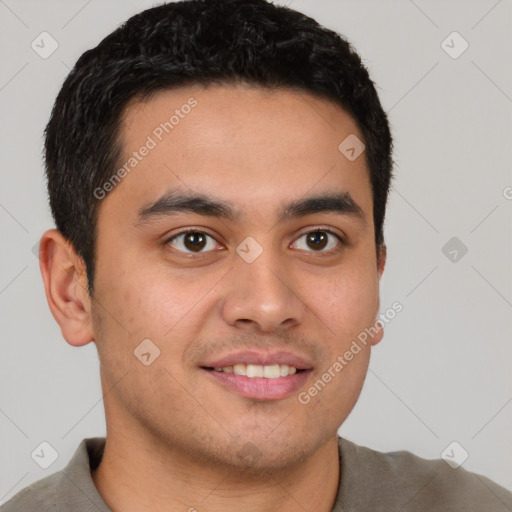 Joyful latino young-adult male with short  brown hair and brown eyes