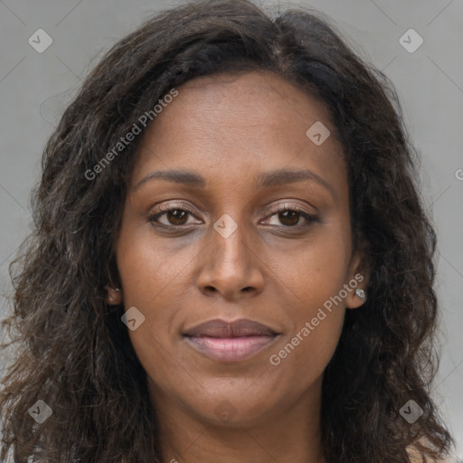 Joyful black young-adult female with long  brown hair and brown eyes
