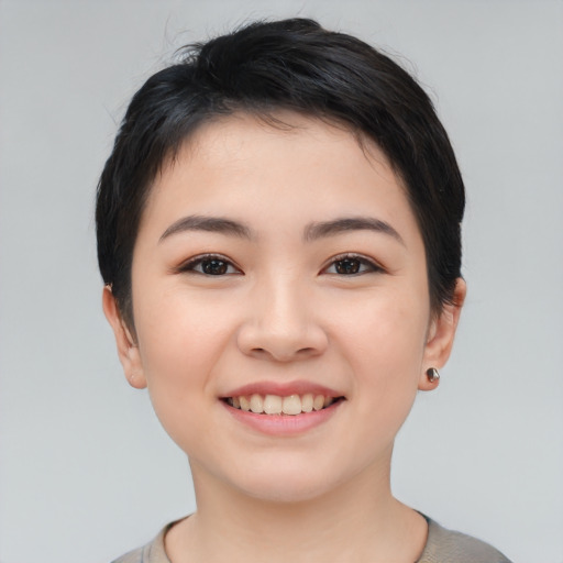 Joyful asian young-adult female with short  black hair and brown eyes