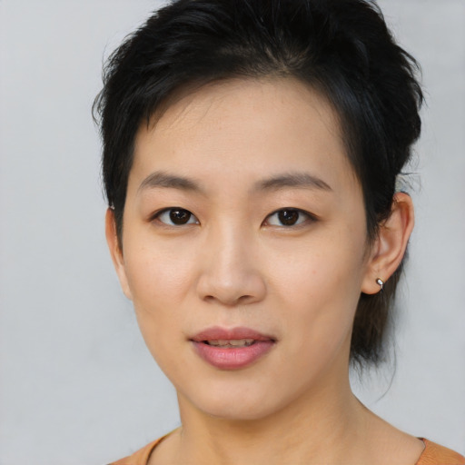 Joyful asian young-adult female with short  brown hair and brown eyes
