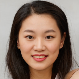 Joyful asian young-adult female with long  brown hair and brown eyes