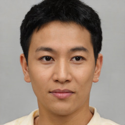 Joyful asian young-adult male with short  brown hair and brown eyes