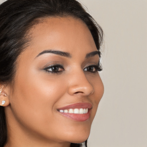 Joyful latino young-adult female with long  brown hair and brown eyes