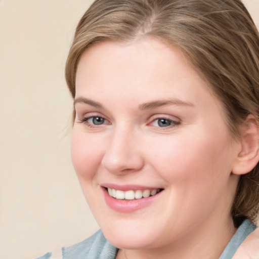 Joyful white young-adult female with medium  brown hair and blue eyes