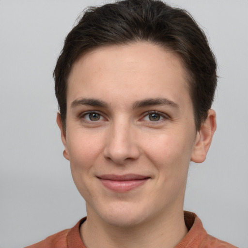 Joyful white young-adult female with short  brown hair and grey eyes