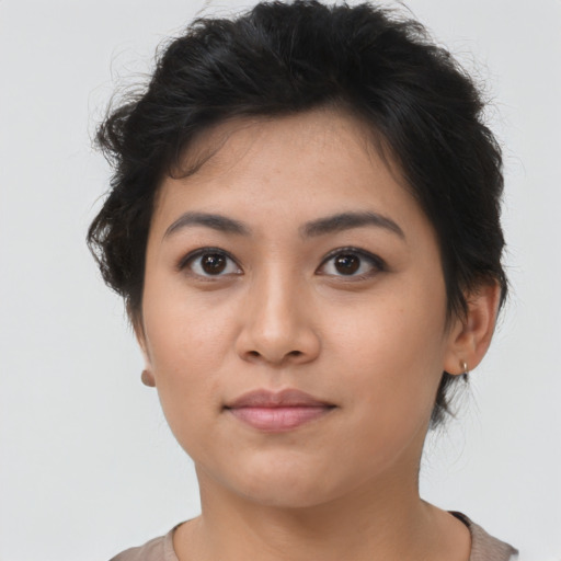 Joyful asian young-adult female with short  brown hair and brown eyes