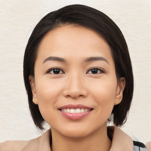 Joyful white young-adult female with medium  black hair and brown eyes